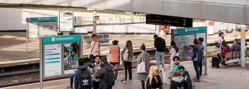 DLR platform with people waiting for a train