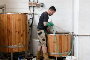 Husk Brewing, brewing in progress in a large wooden tank