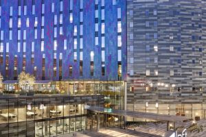 Aloft hotel exterior.  It looks like a blue wave made of glass