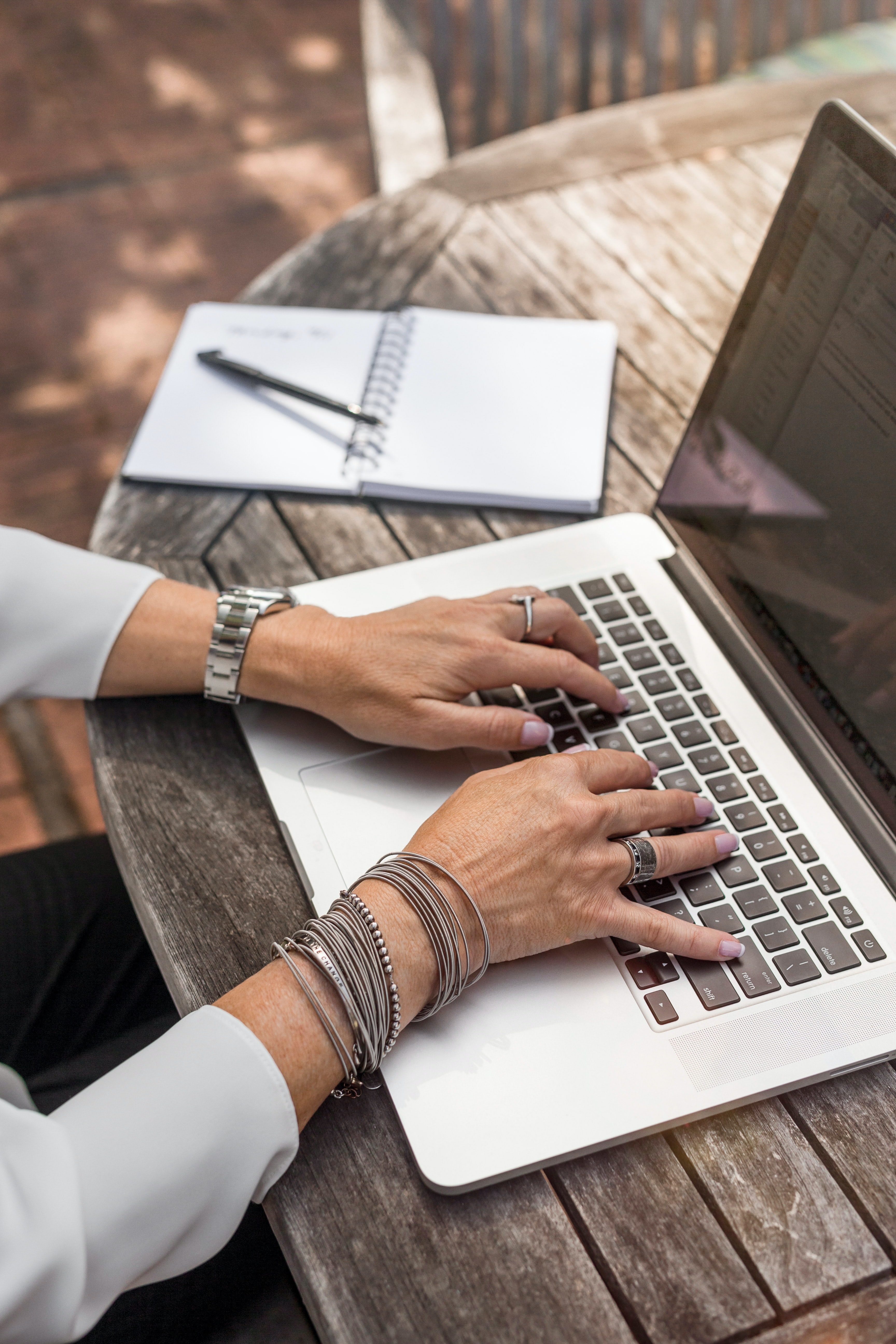 Hands typing on laptop