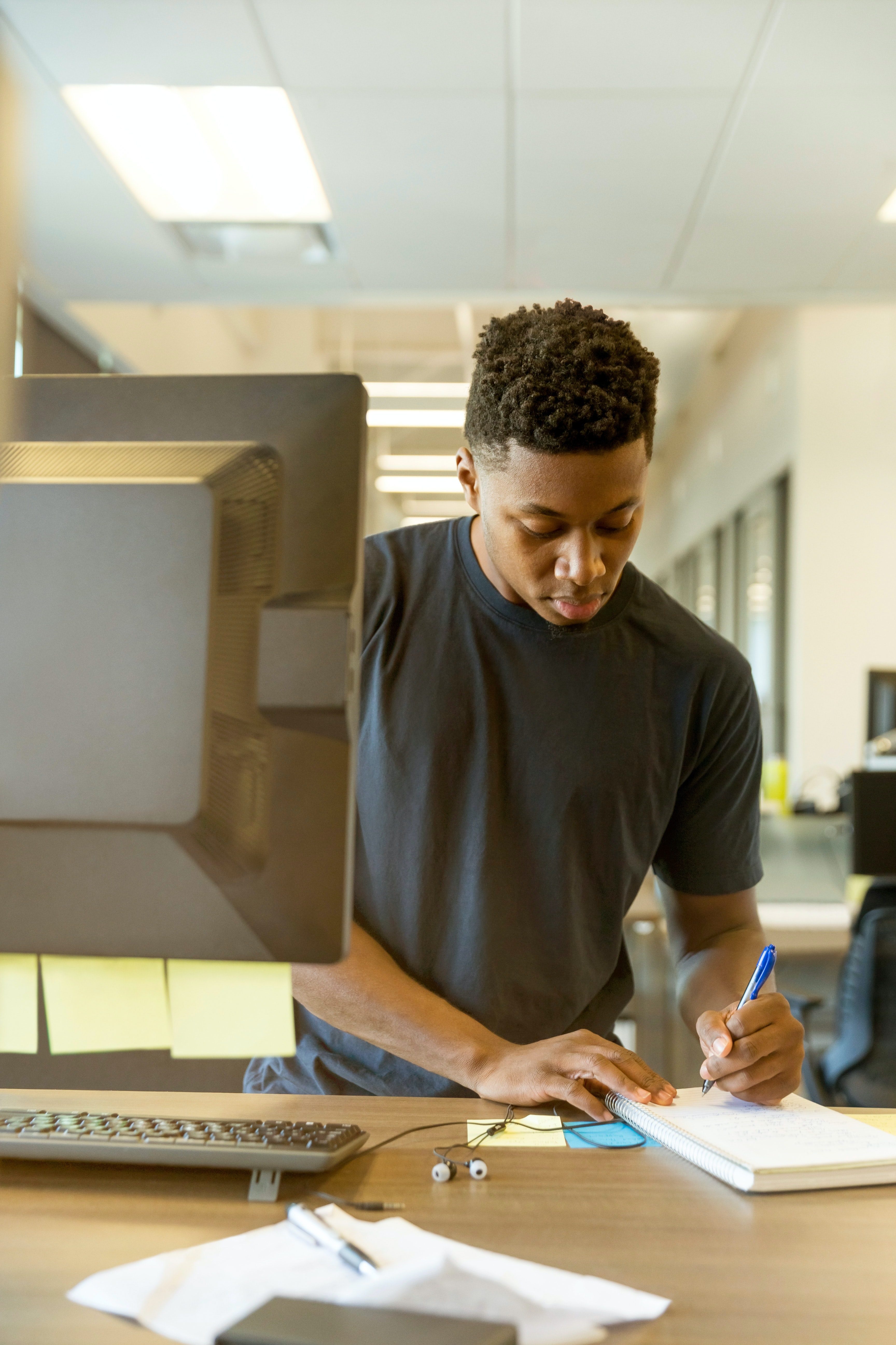 Man making notes by computer