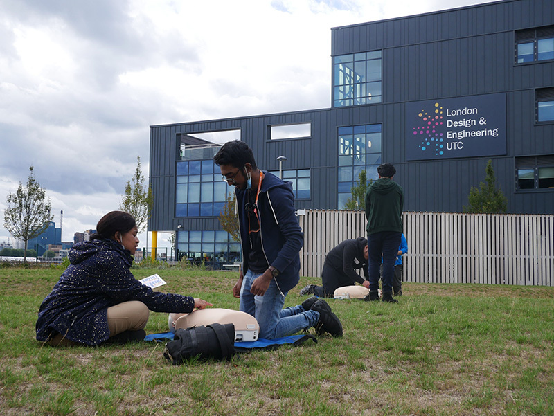 Two students outside the London Design and Engineering building