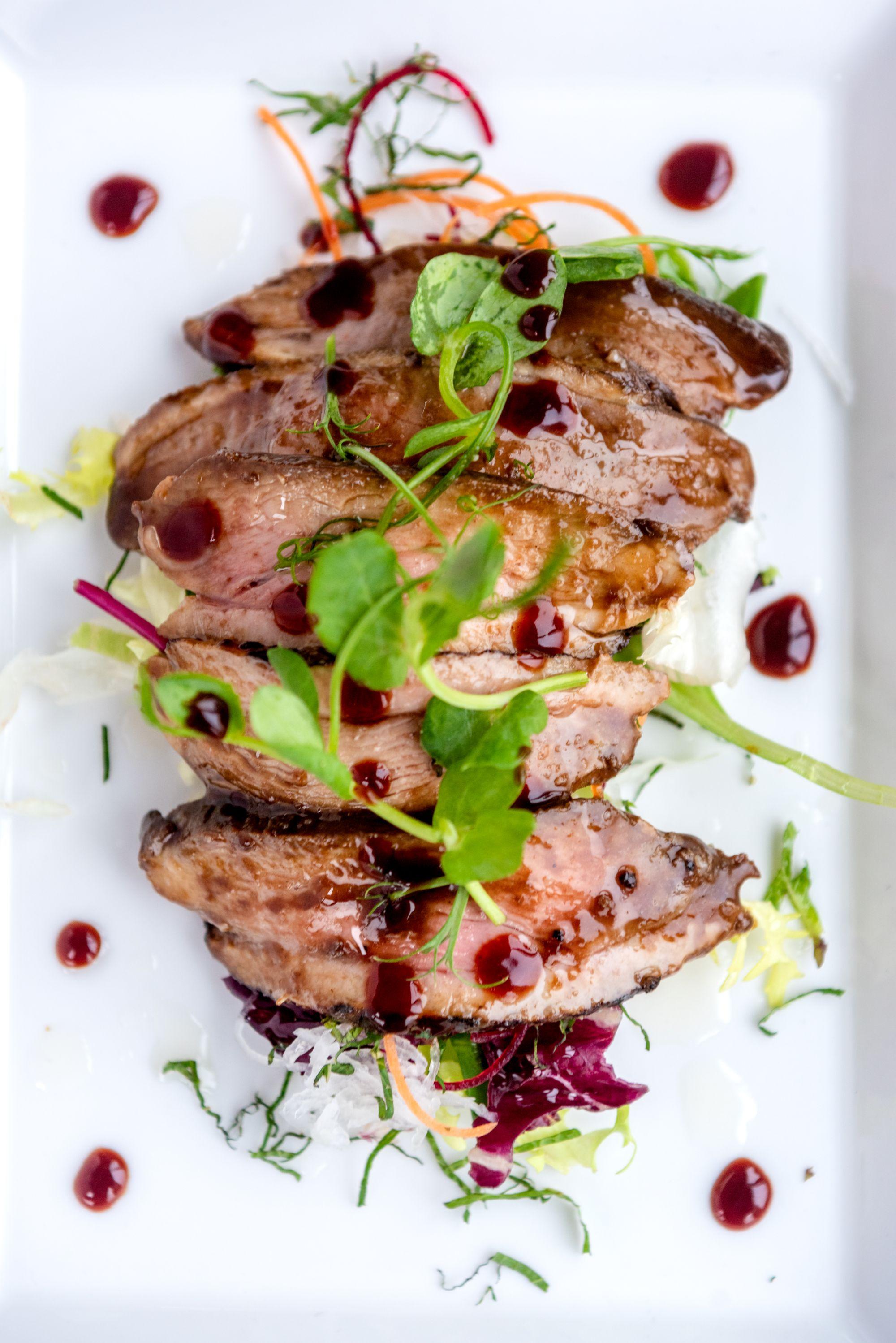 Smoked duck arranged artfully on a plate