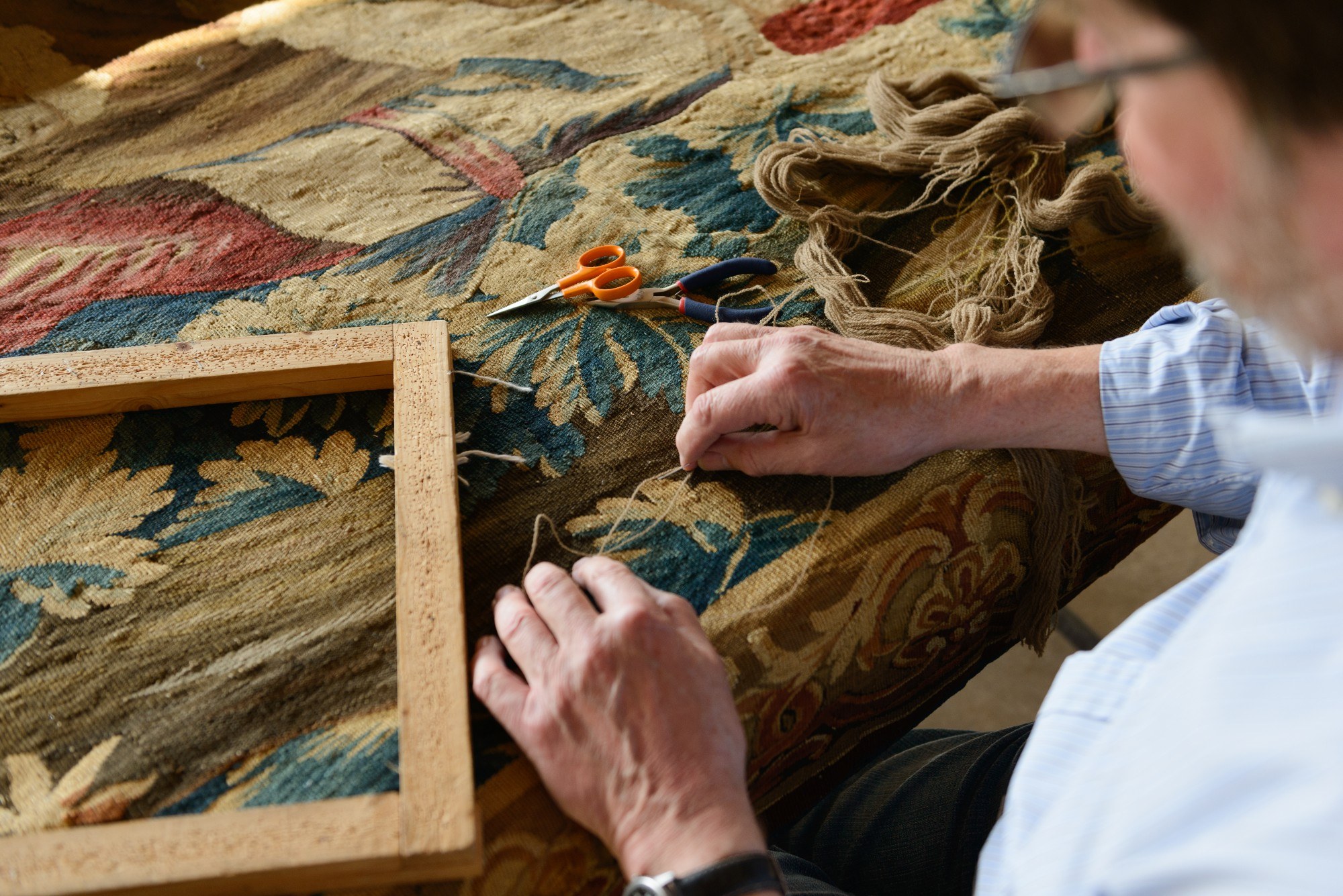 Man working on a tapestry