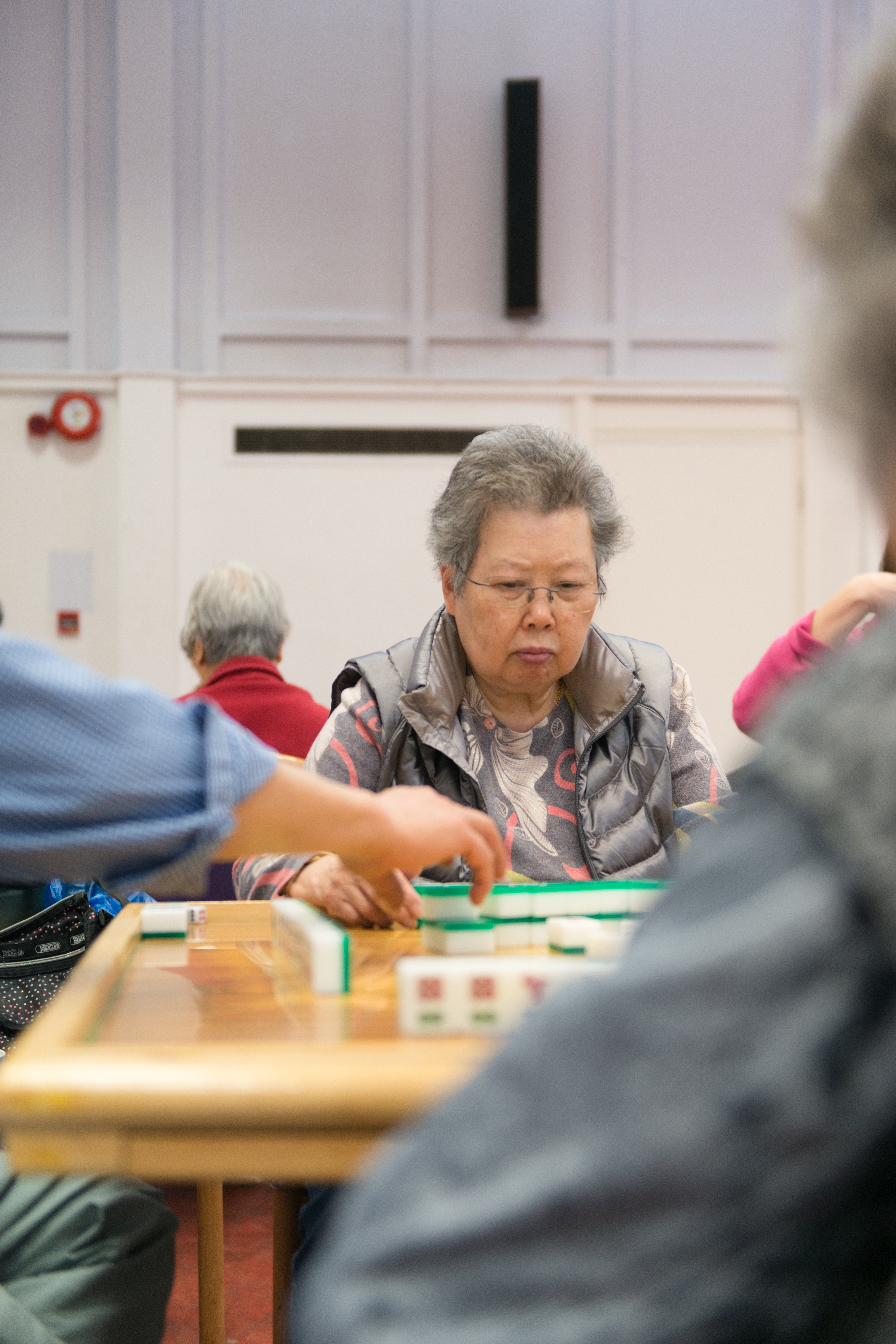 Lady playing with Mahjong tiles