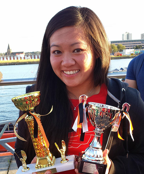 Cheryl Phan holding two trophies