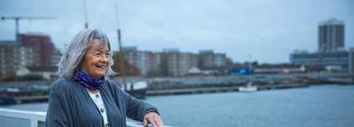 Marian Phillips on a bridge overlooking the Royal Docks