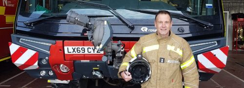 Paul Foster standing by a London City Fire Brigade truck