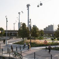 Scene with planting, people and cable cars overhead