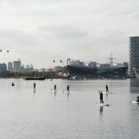 Overview of Royal Victoria Dock with the Crystal, with wakeboarders on the water