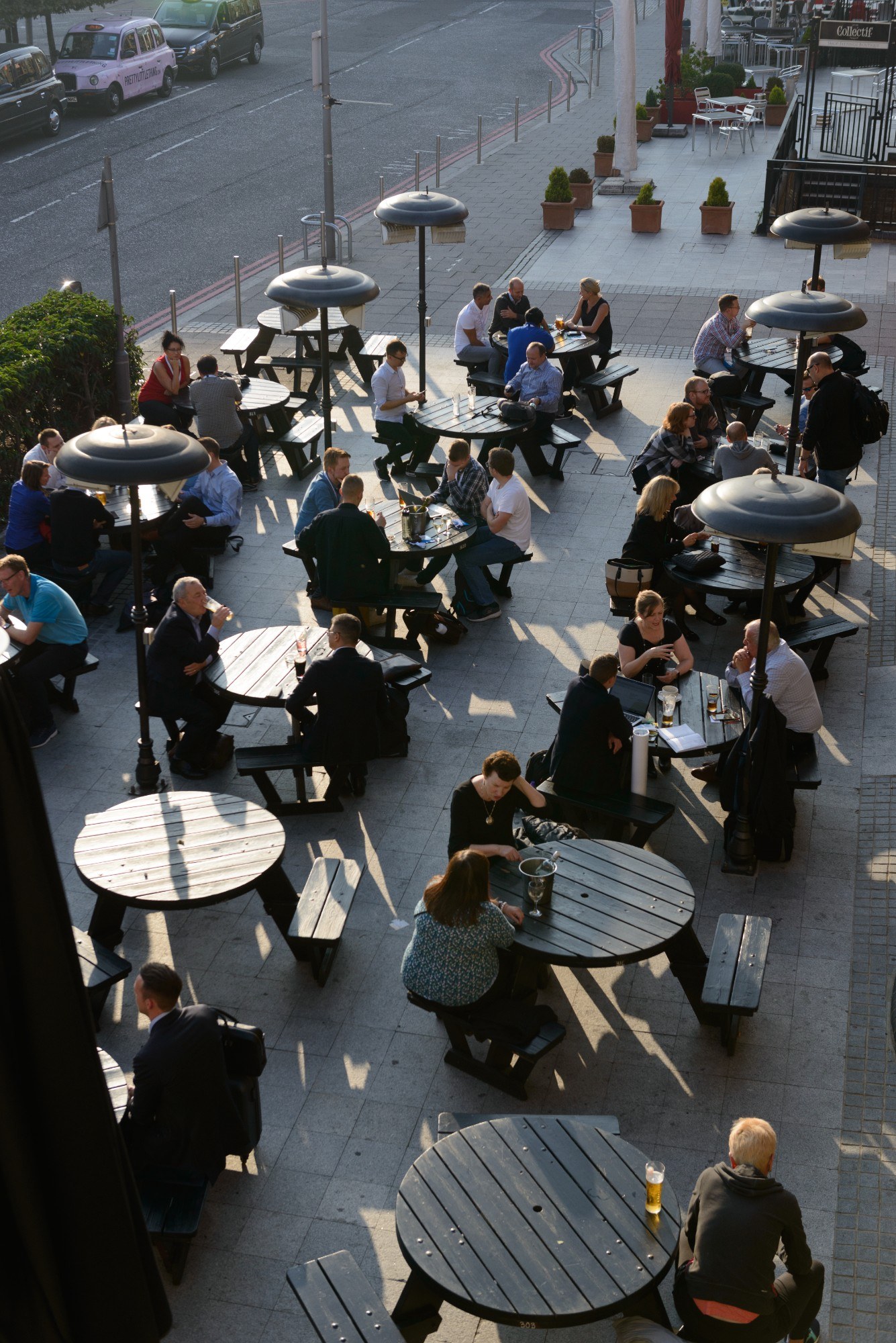 People sat at tables outdoors near ExCeL