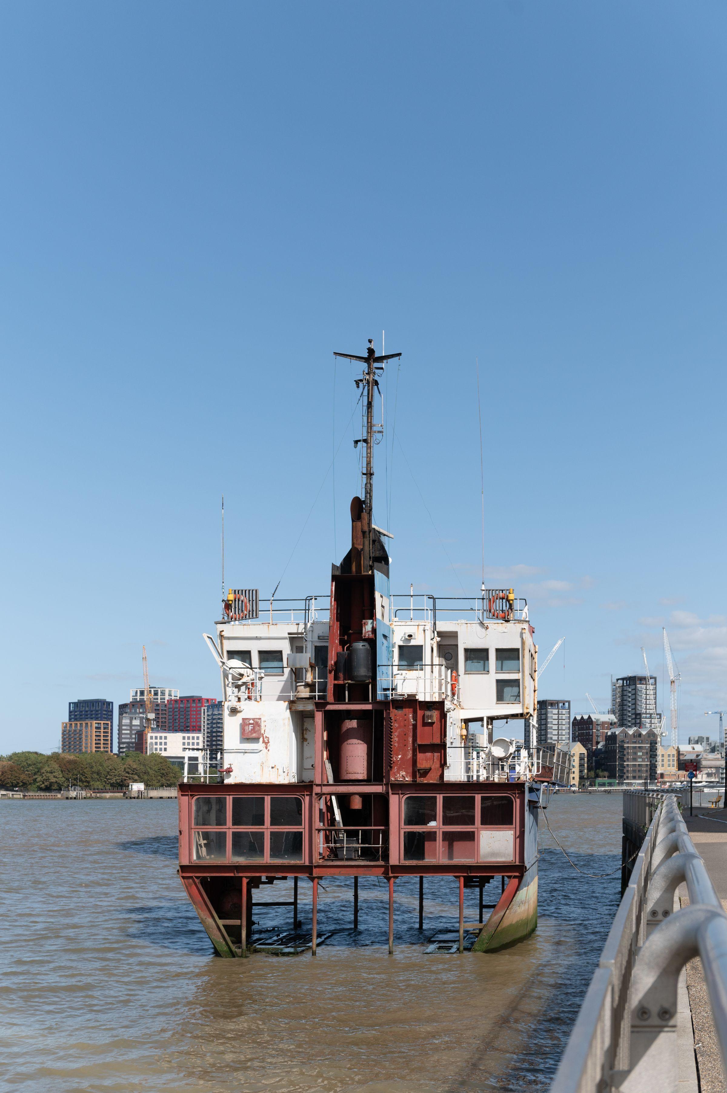 Boat that has been cut in half vertically sitting on the Thames foreshore