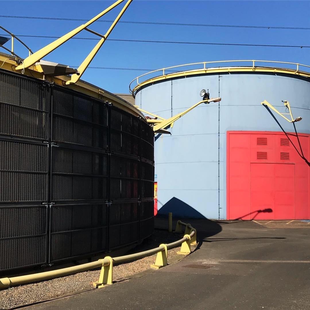 the blue tidal basin pumping station with a red door and yellow piping