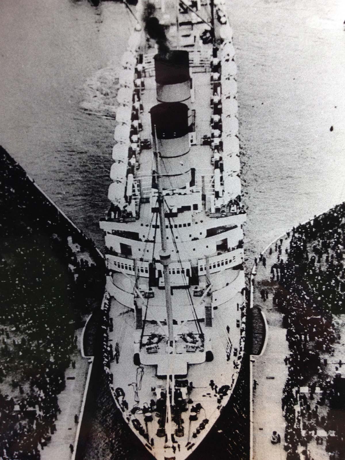 The RMS Mauretania entering King George V Dock; photo: Newham Archives and Local Studies. The view from Woolwich Manor Way today, looking north into the dock; photo: Sam Bush. Header photo: Kiron Ponnath.