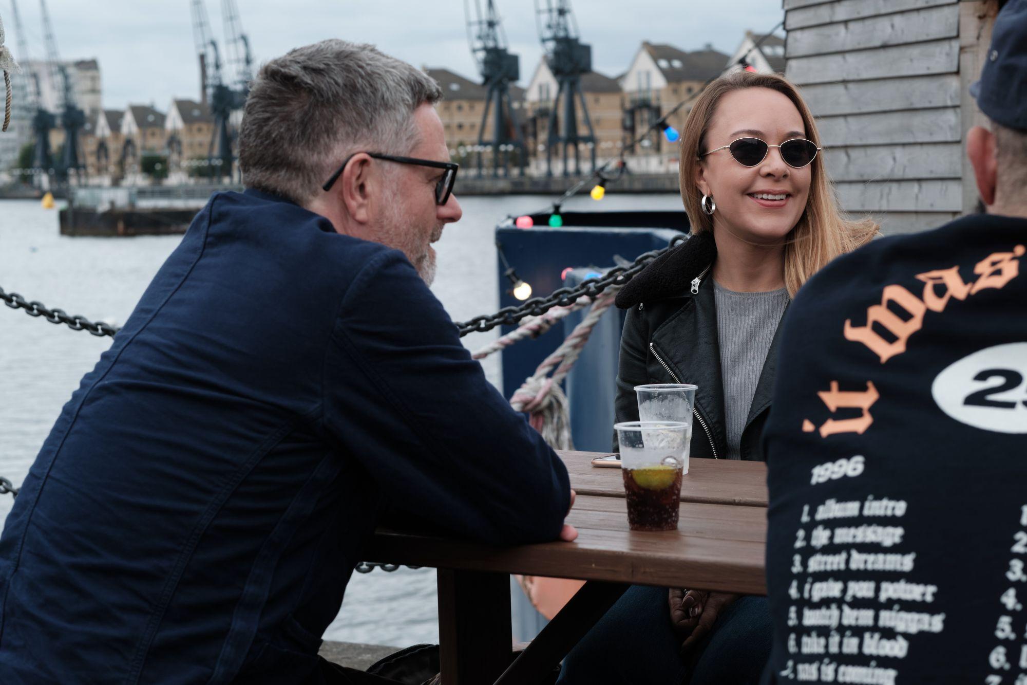 The trio sitting and talking together in the docks