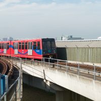 DLR train travelling along the tracks in the Royal Docks