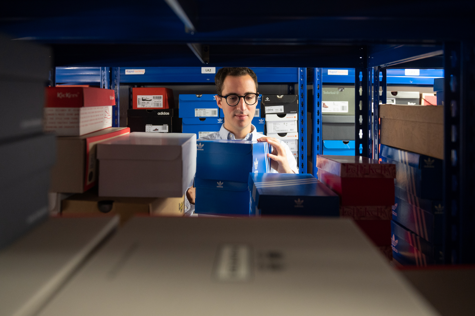 Eralp picking down boxes from warehouse shelves