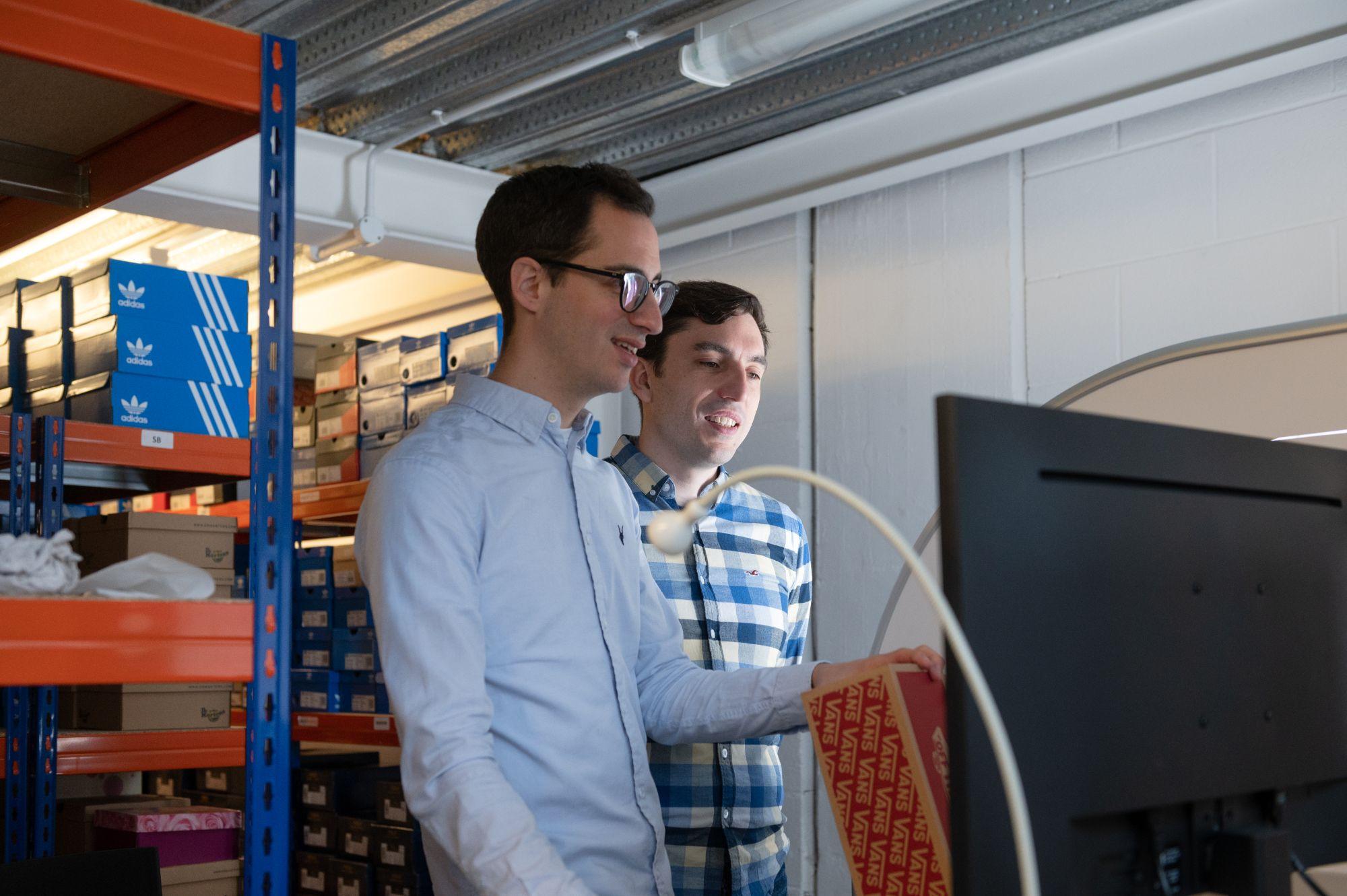 The co-founders of Awesome Shoes looking at a screen