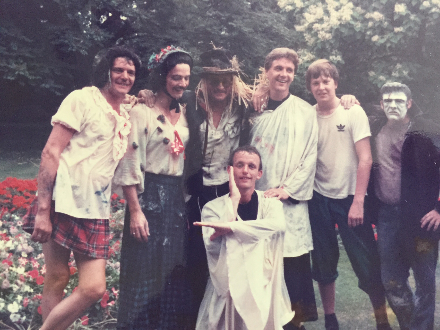 Group of men wearing costumes and smiling