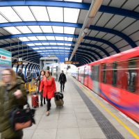 A DLR station platform with a departing DLR train.