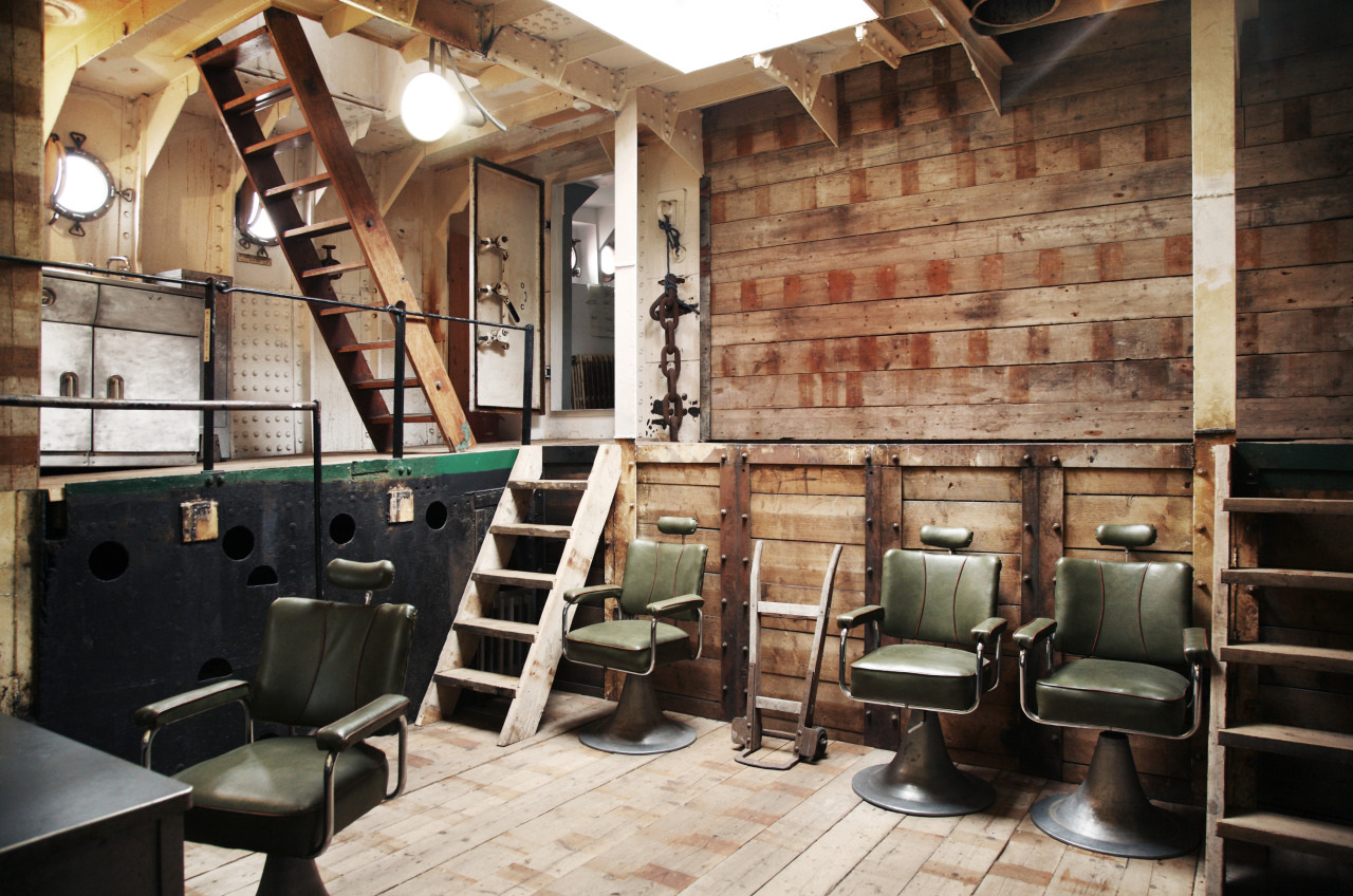Interior of boat with green leather chairs and wooden walls