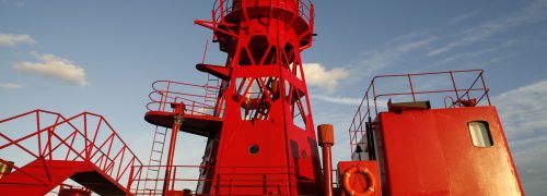 Red lighthouse tower on boat
