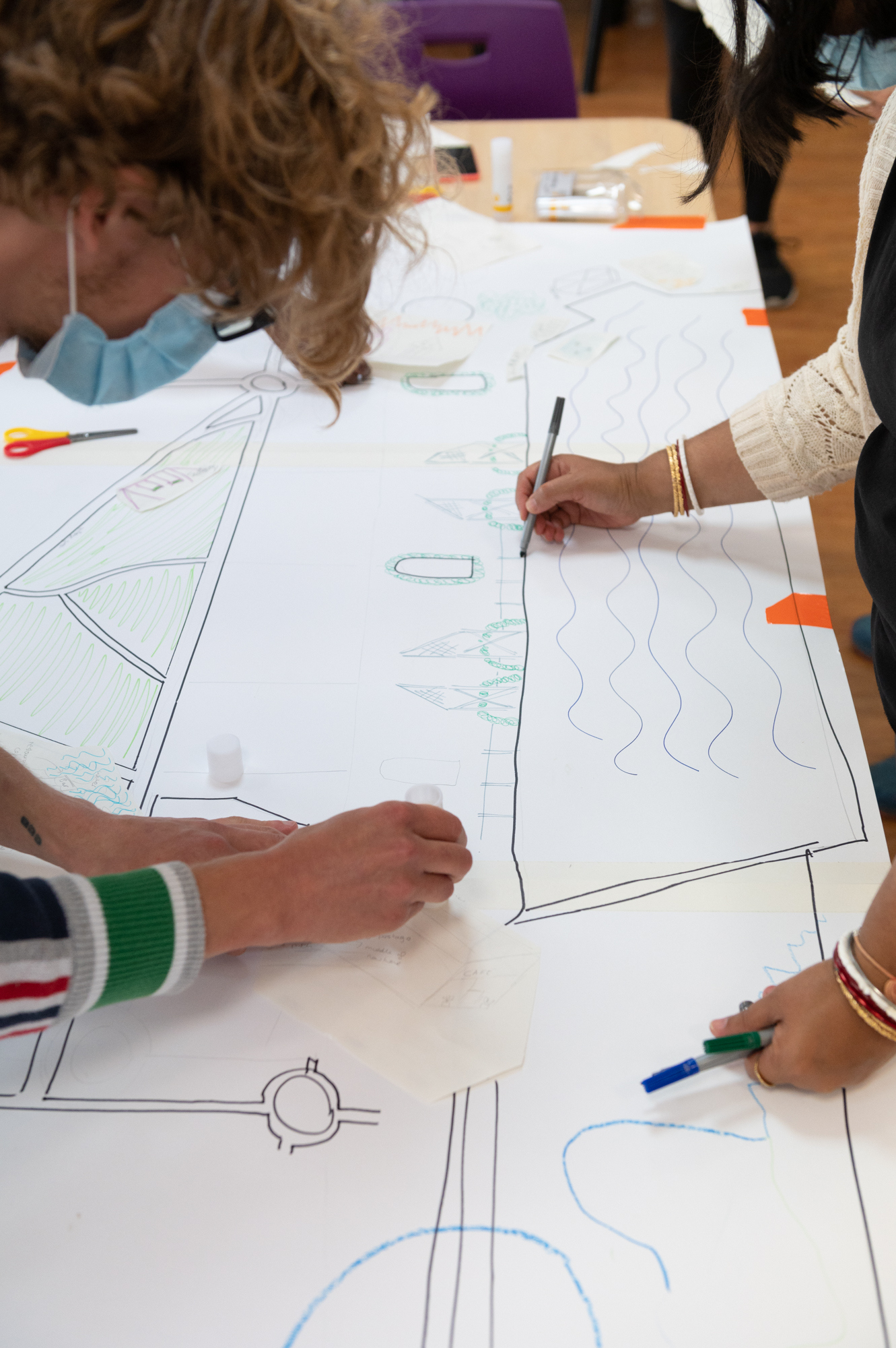 Group annotating a drawing of the Royal Docks