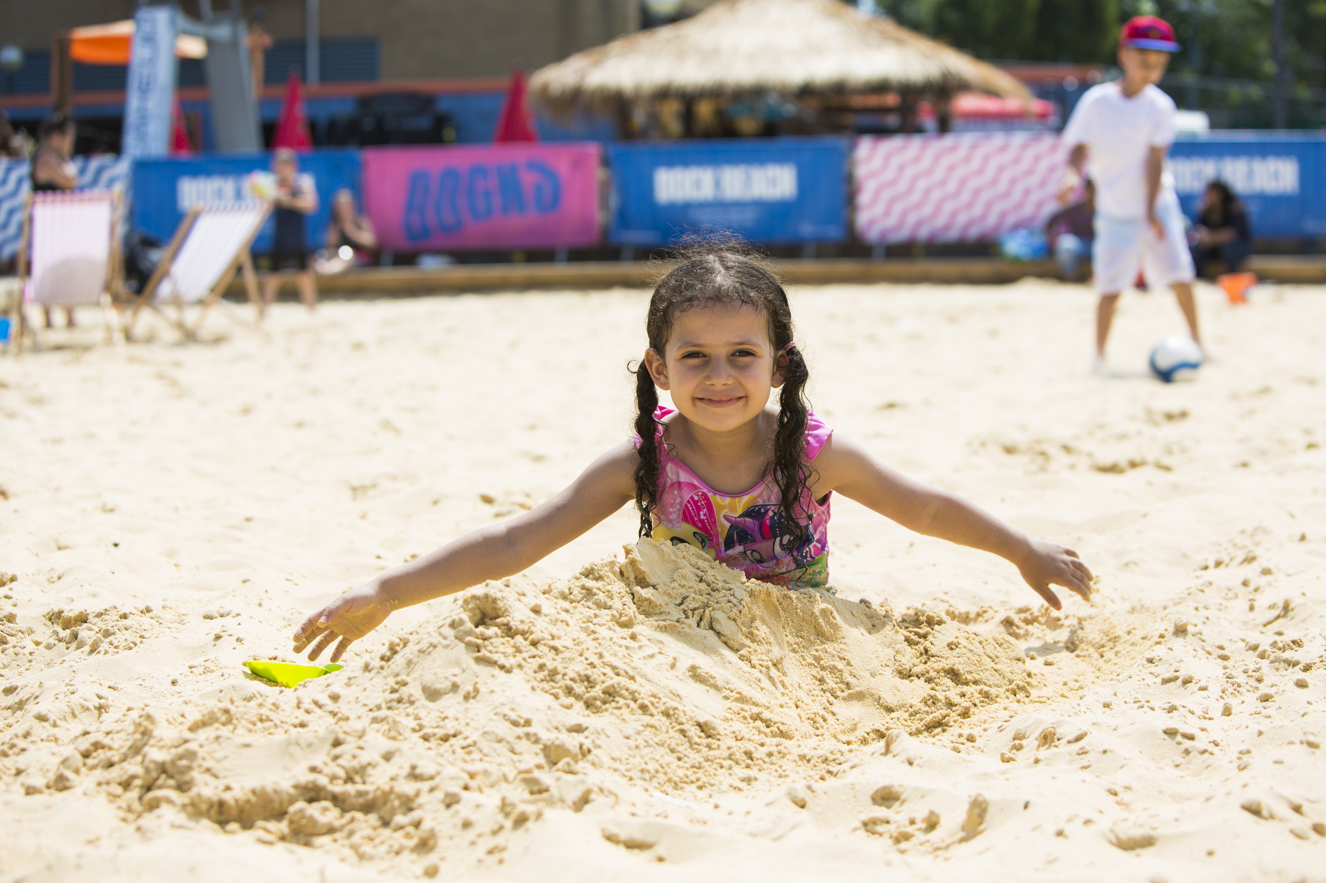 Child playing in sand at Join the Docks