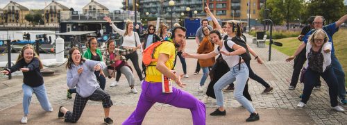 Guru Dudu with a crowd of people at the Royal Docks