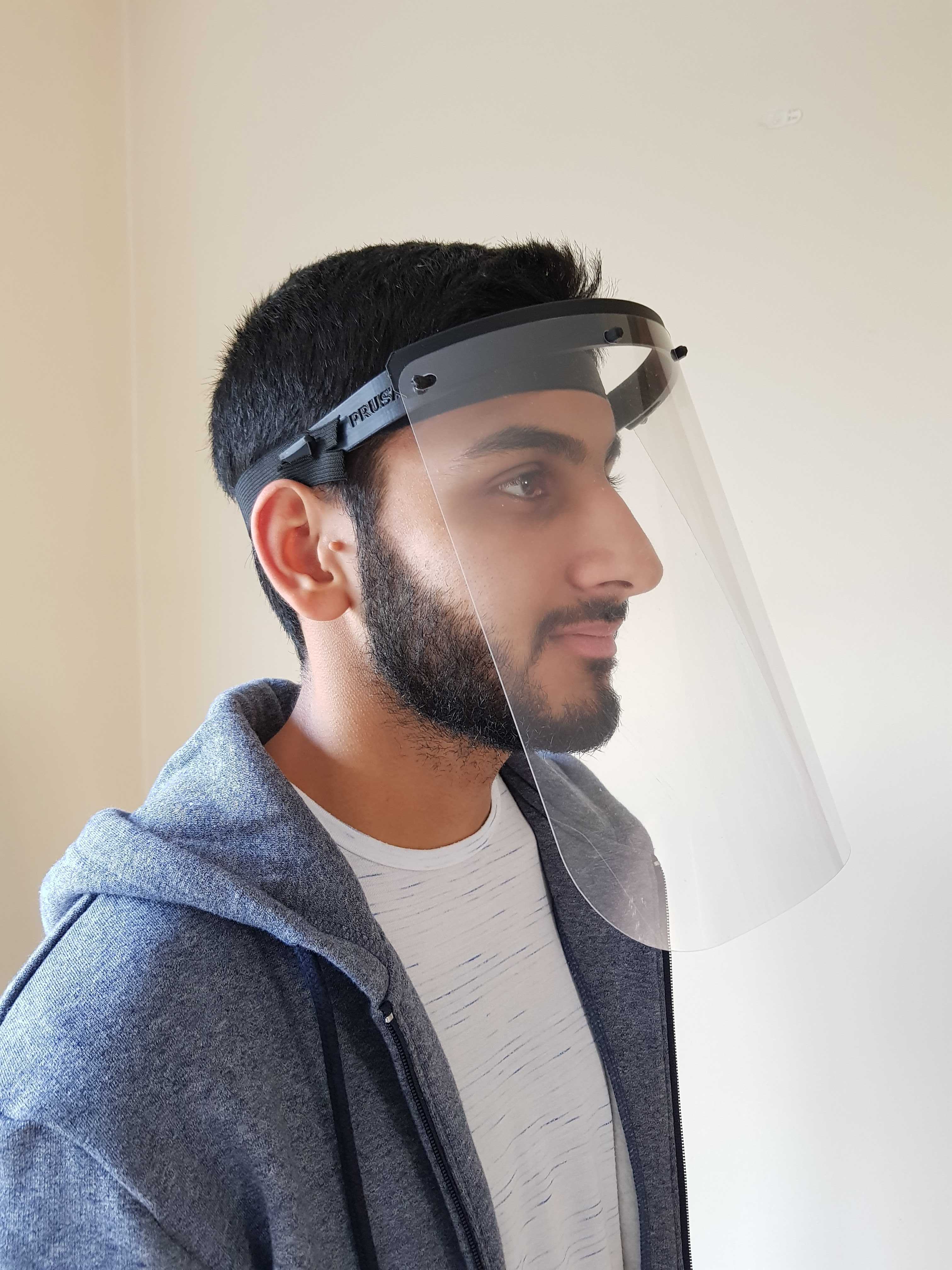 Young man wearing a plastic face visor