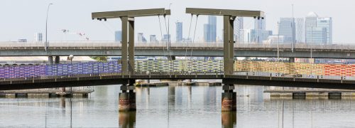 Bridge over Royal Albert Wharf decorated in rainbow ribbon