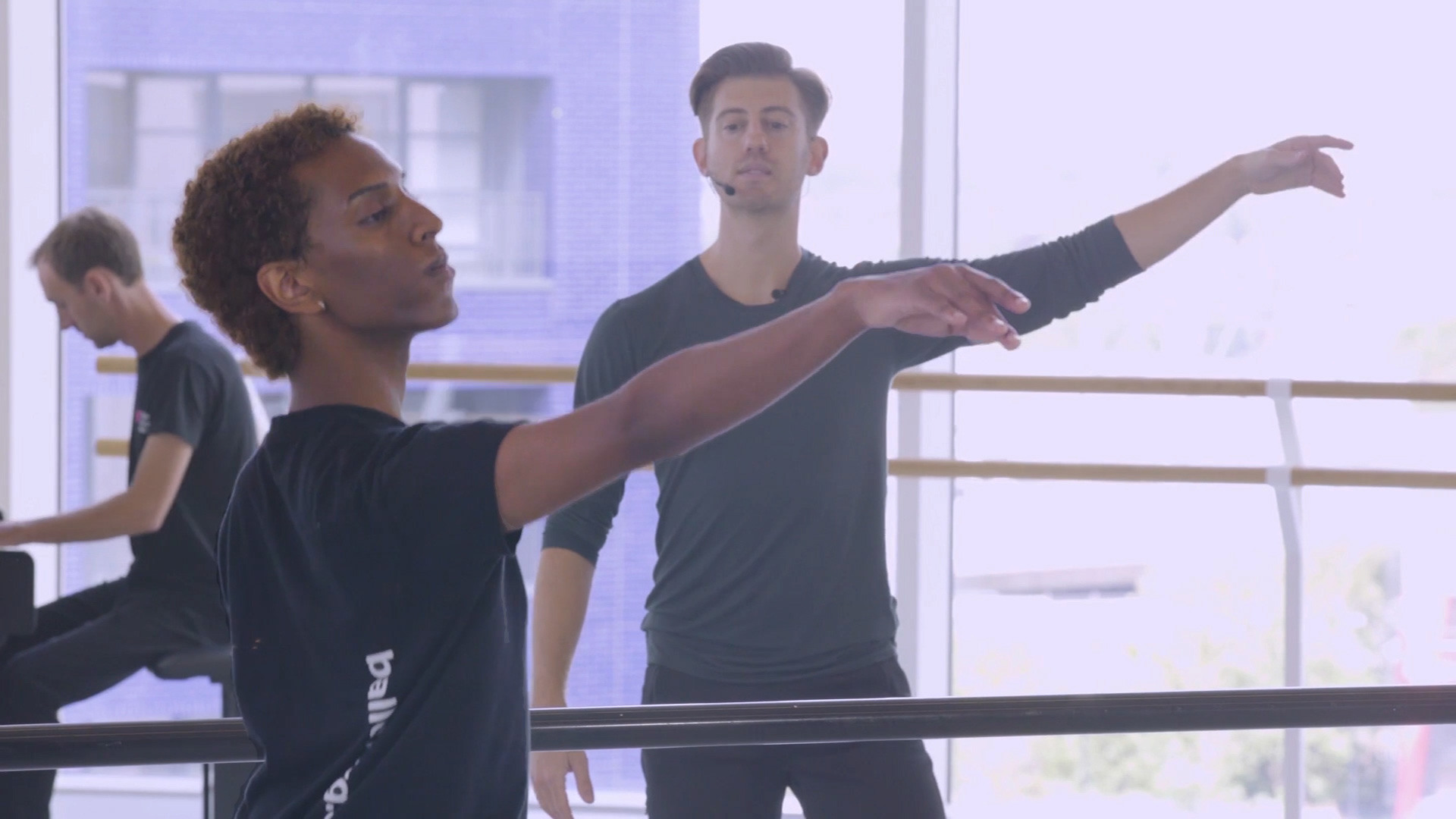 Three people practising ballet