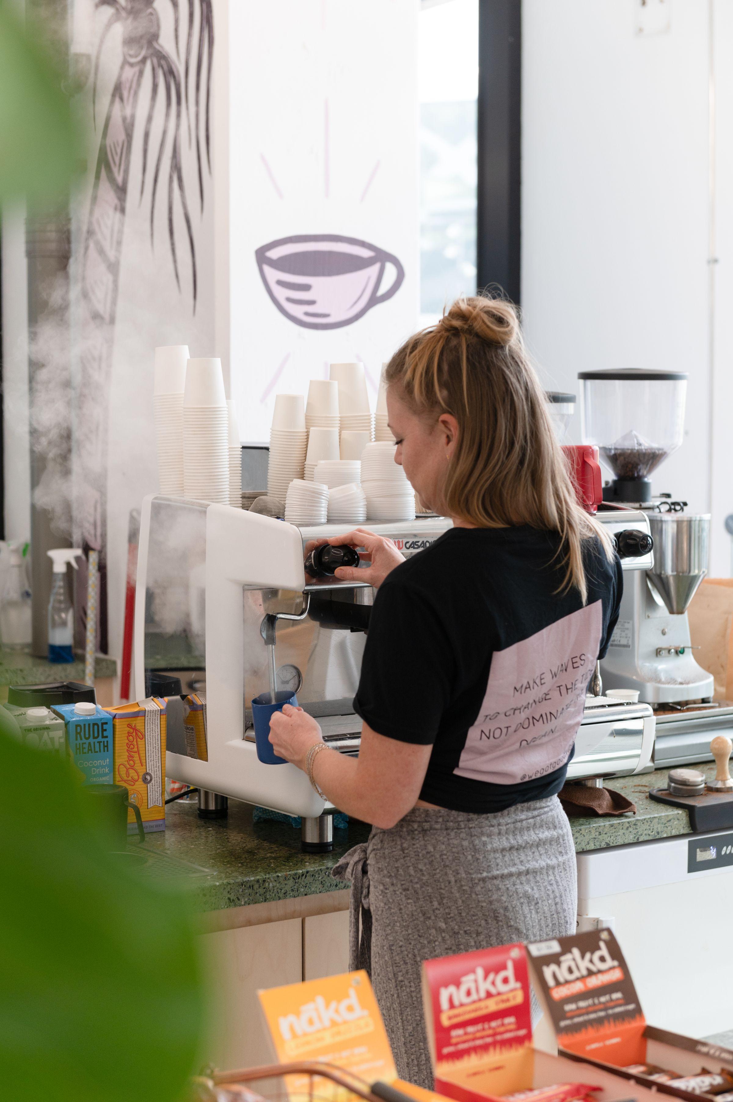 Woman making coffee with pro machine