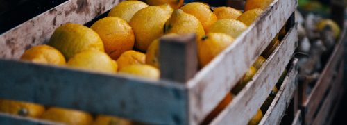 A wooden crate full of lemons