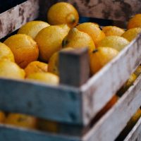 A wooden crate full of lemons