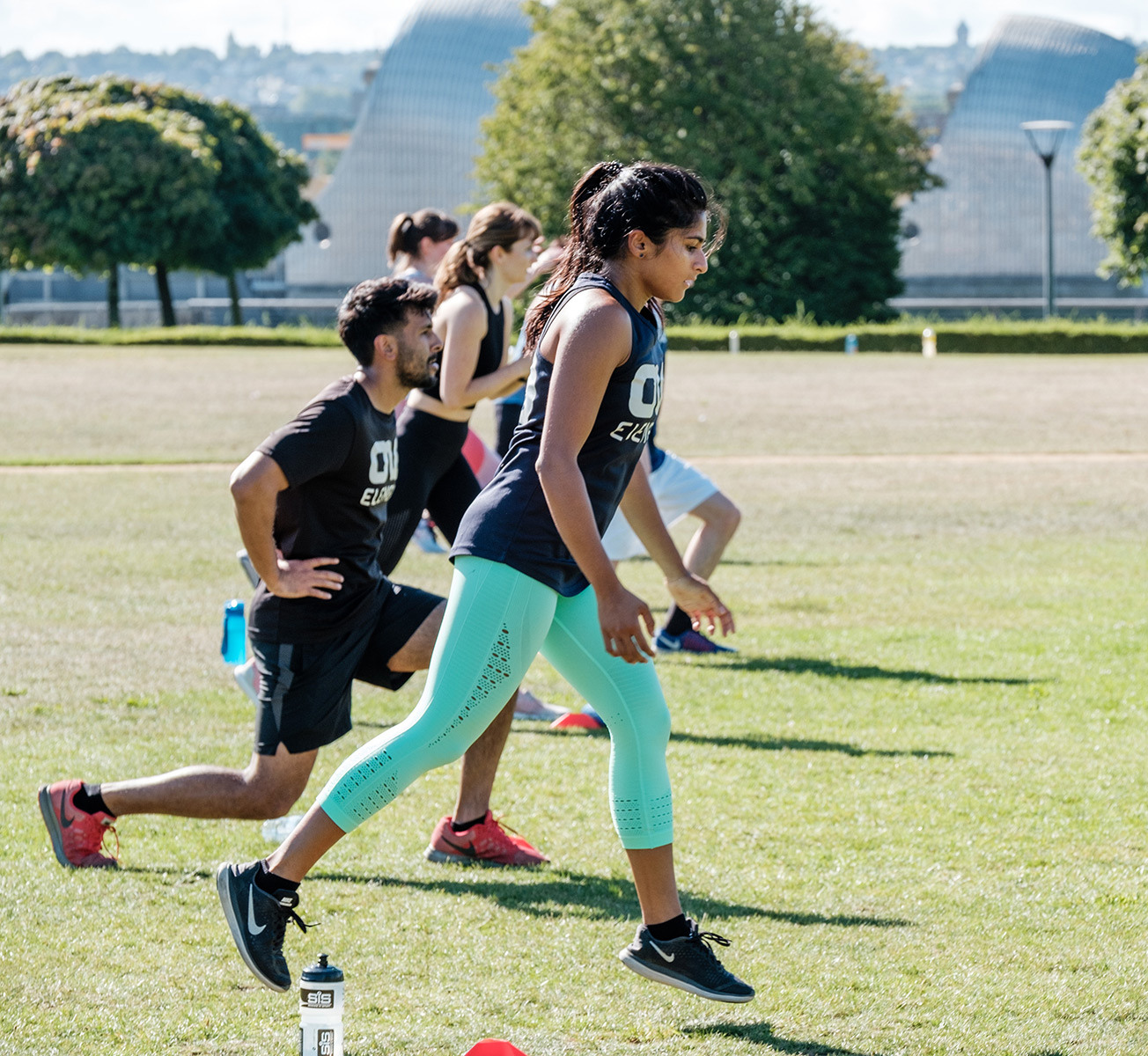 Group of people on a HIIT fitness session in Thames Barrier Park