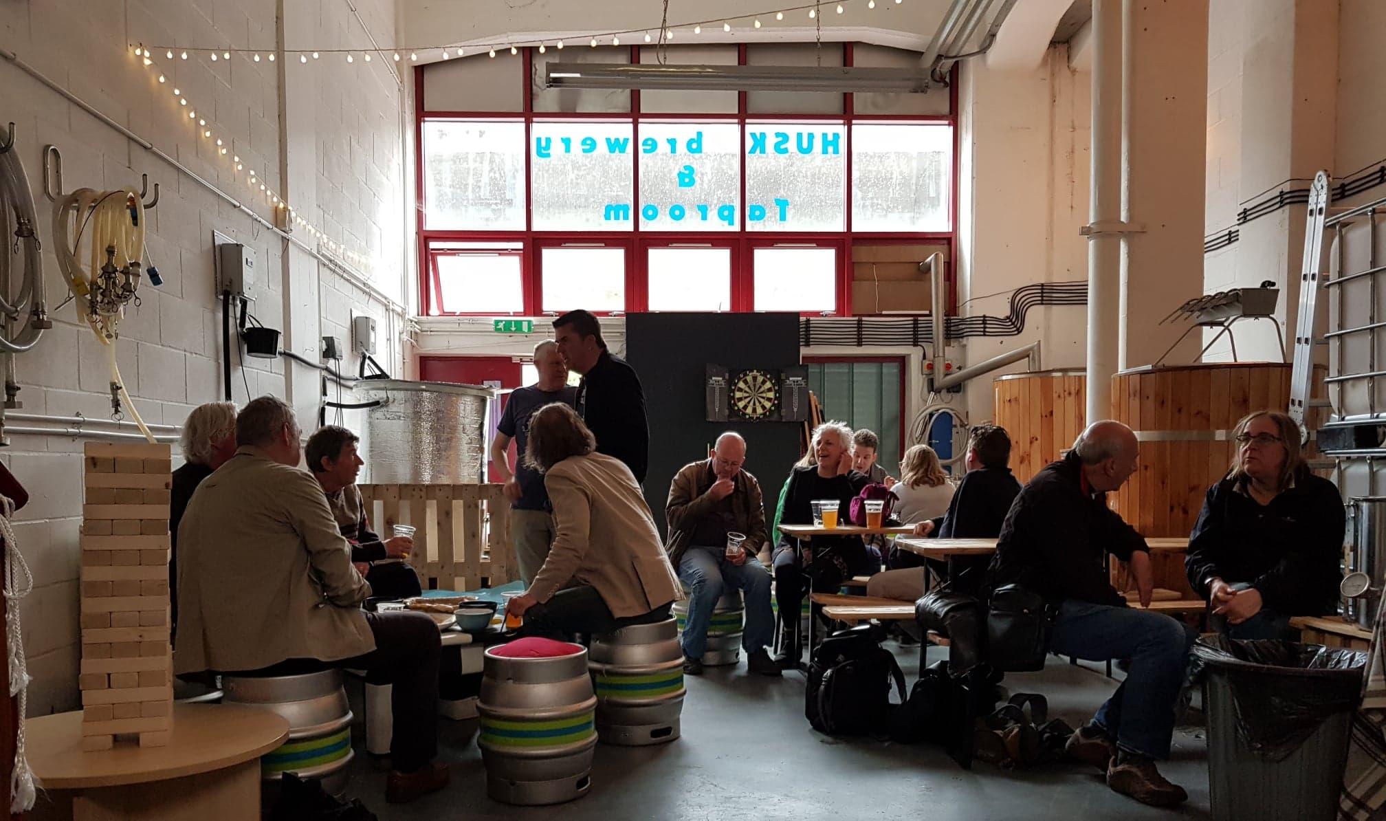 A crowd enjoying beer at Husk Brewing