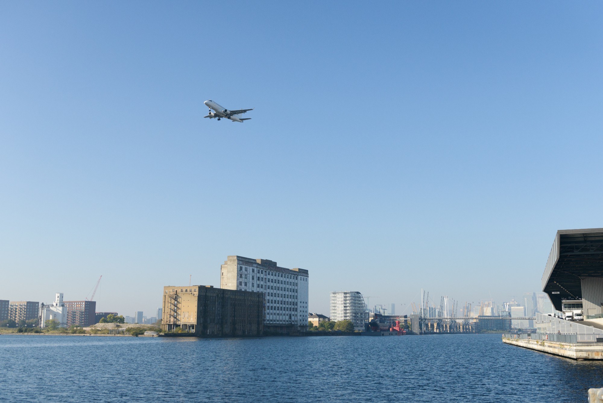 A plane flying over Millennium Mills