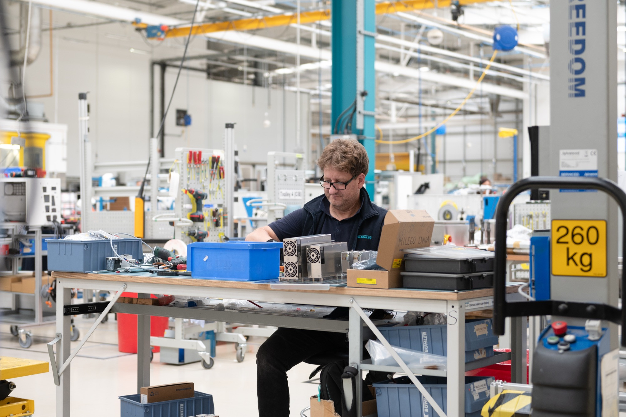 Buhler in the Royal Docks, man at a desk in a large industrial space