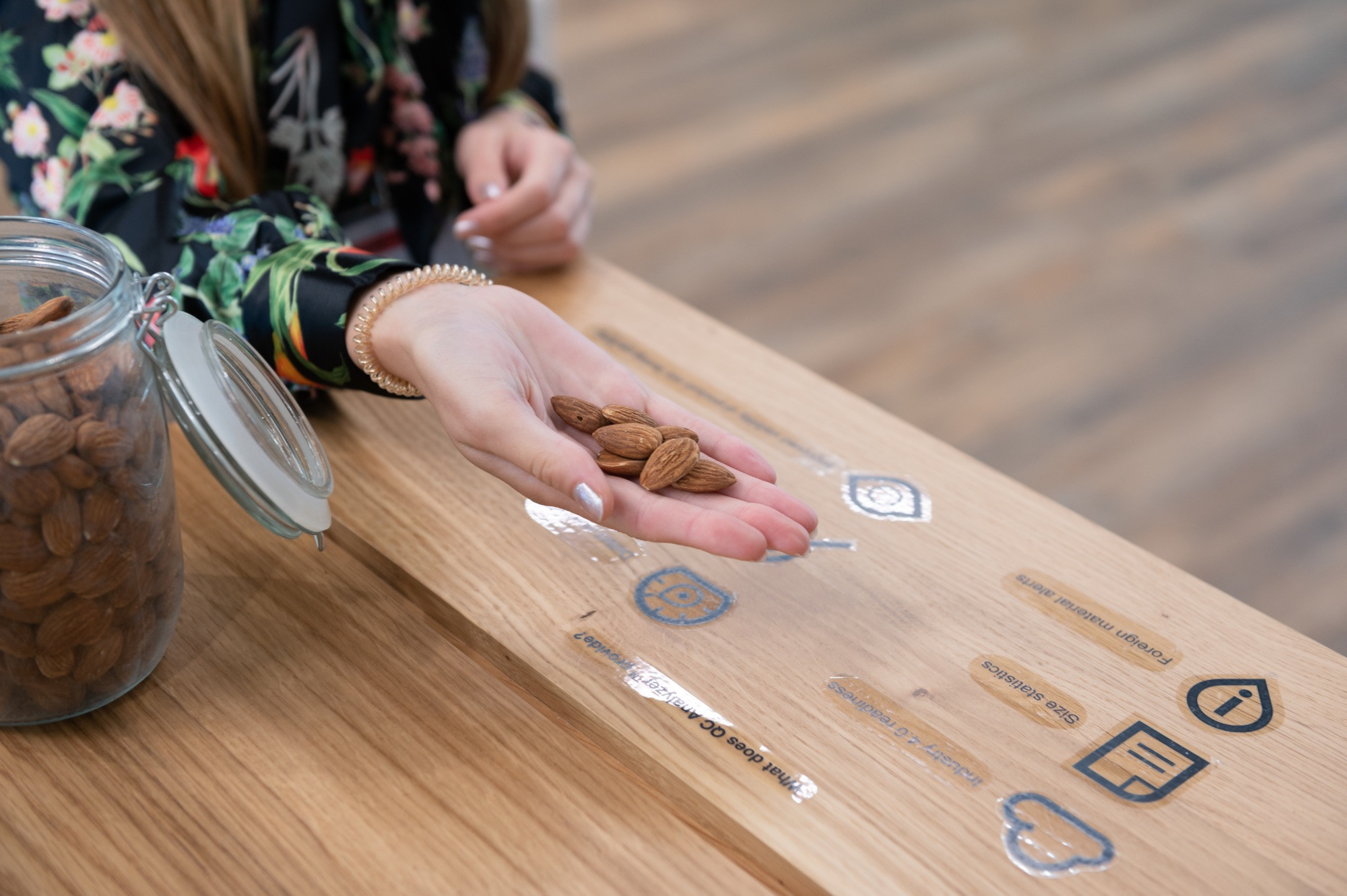 Buhler in the Royal Docks, woman's hand holding almonds