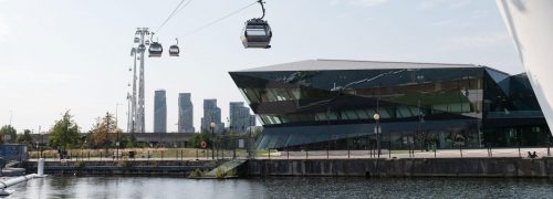 The Crystal building with cable cars passing overhead