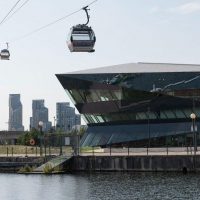 The Crystal building with cable cars passing overhead