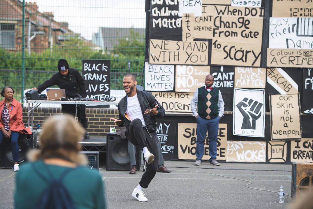 Dance performance in front of Black Lives Matter protest signs