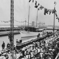 A historical photo of boats and crowds at the Royal Docks