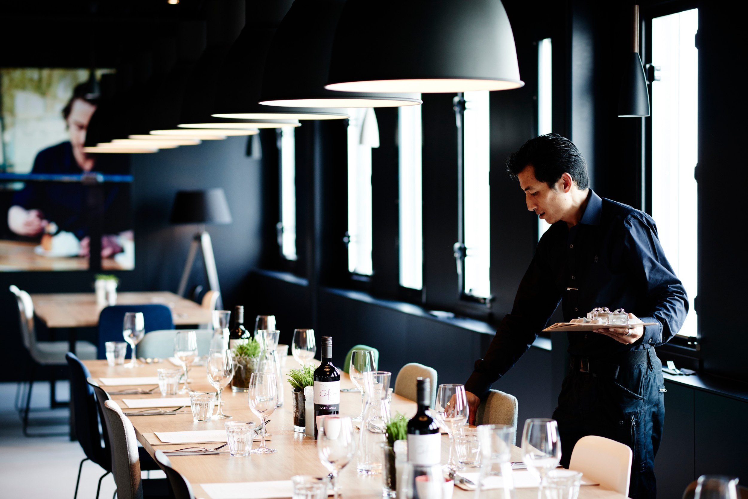 A table being set at the Good Hotel