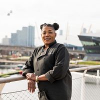 Photograph of Ona Brown in front of the Royal Docks