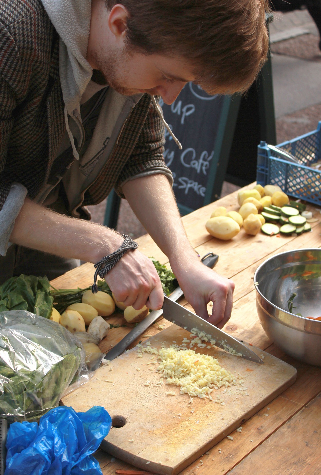 A man chopping vegetables on a chopping board