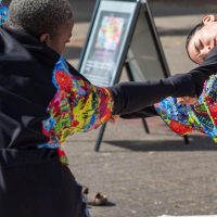 Two women dancing at Queens' Roar event