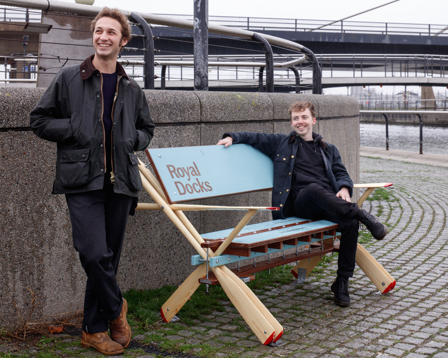 Standing by a bench at the Royal Docks