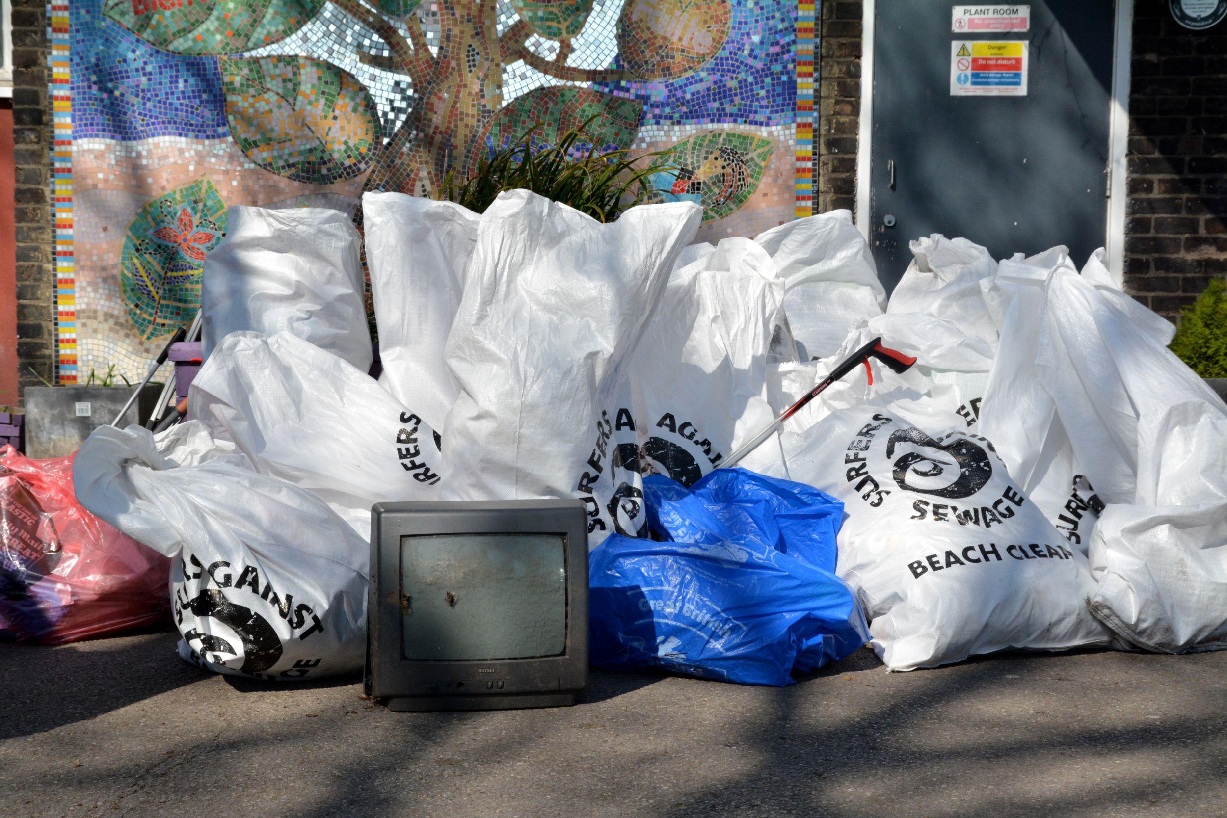 A collection of refuse sacks filled with litter